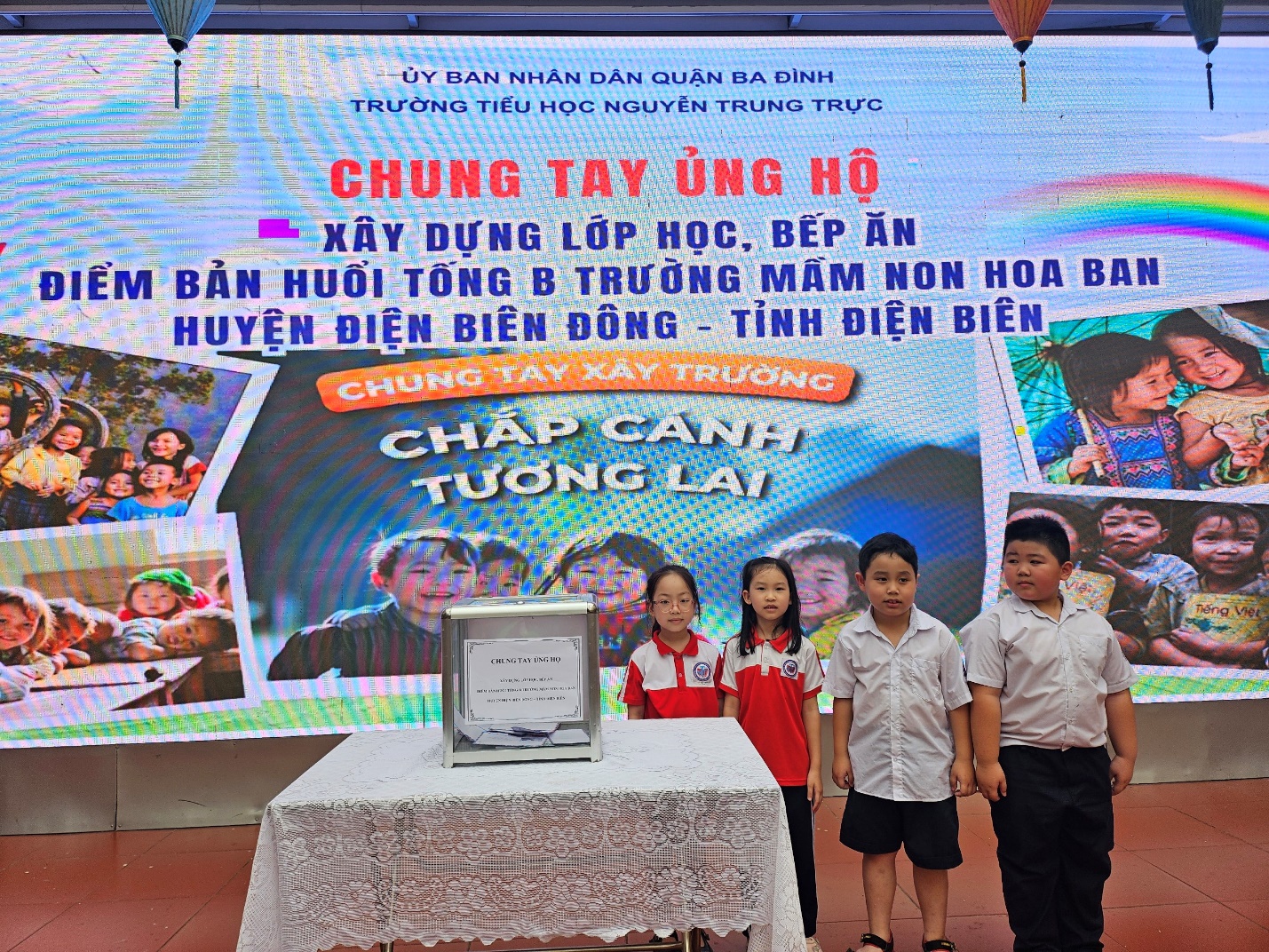 A group of children standing in front of a large sign

Description automatically generated